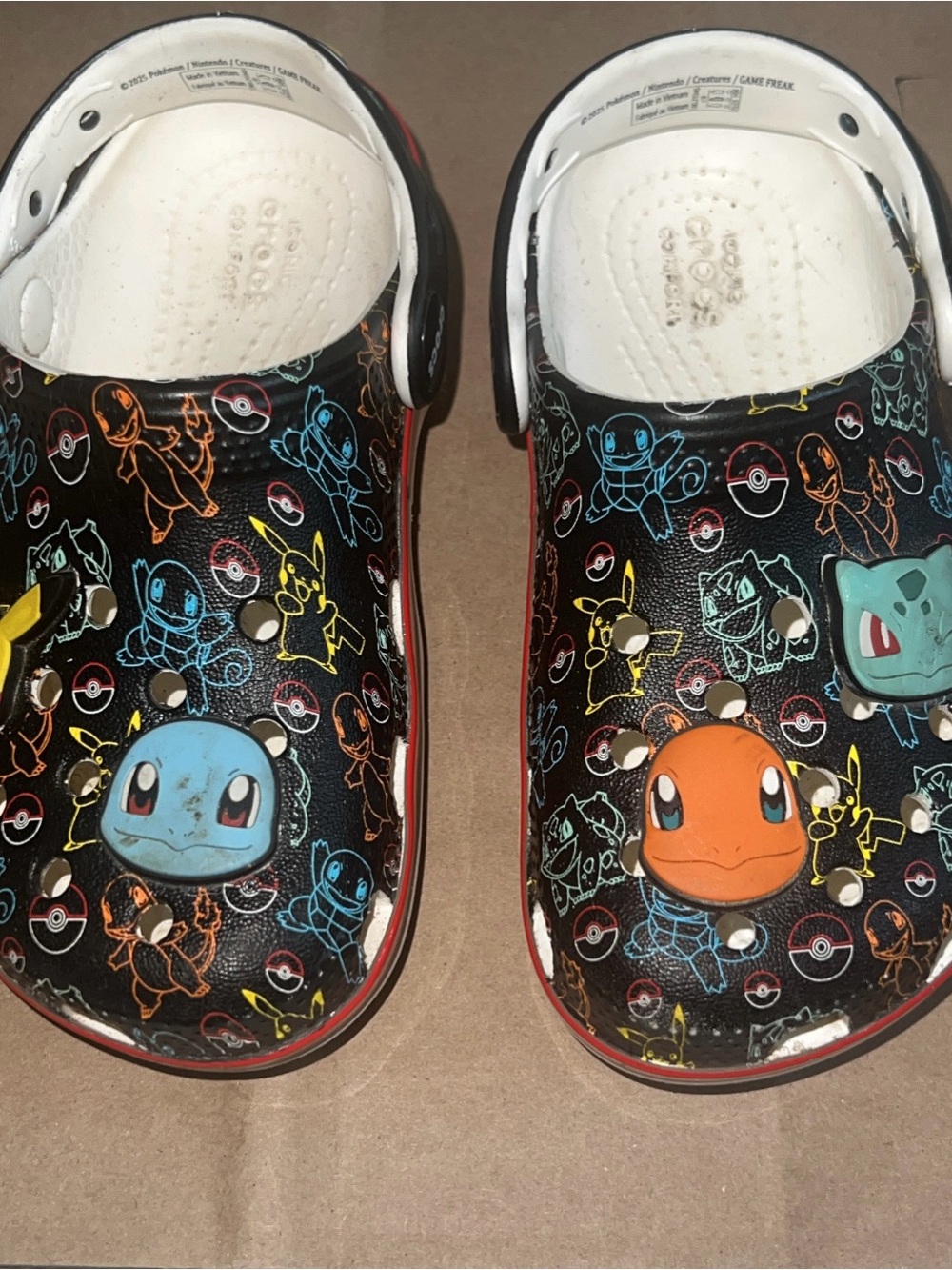 CROCS Kids Pokémon Slip-On Clogs in Black with Blue and Orange Accents